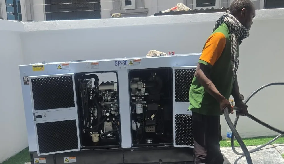 Engineer installing 30kVA soundproof diesel generator successfully delivered in Ologolo Lekki Lagos
